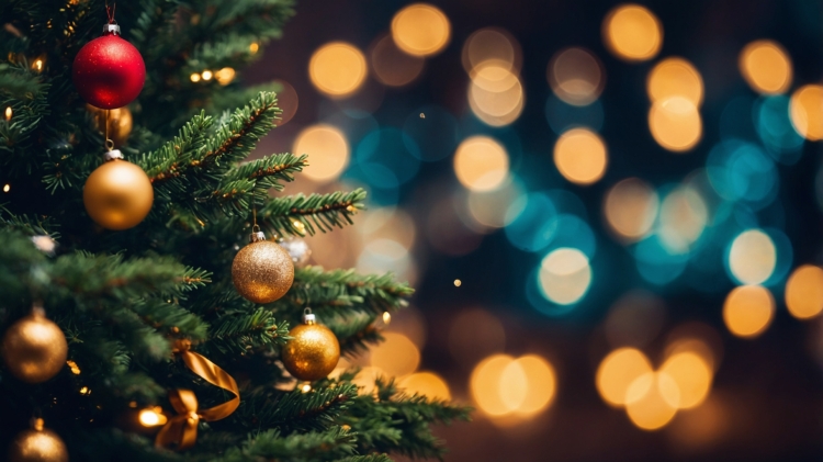 Close-up of a Christmas tree adorned with golden and red ornaments, set against a blurred lights background with copy space.