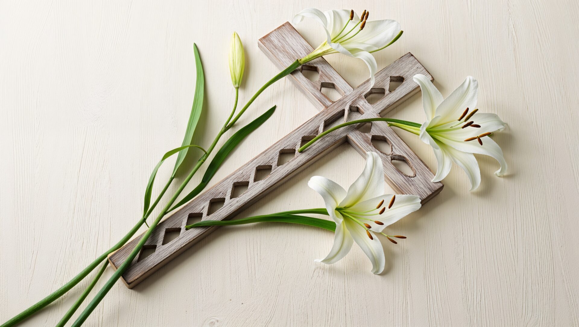 Wooden cross with white lilies on a light background, captured in a flat lay style for a serene composition.