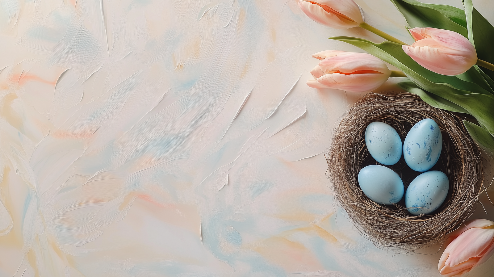 Blue eggs in a bird's nest with tulips on a pastel beige table, top view with copy space.