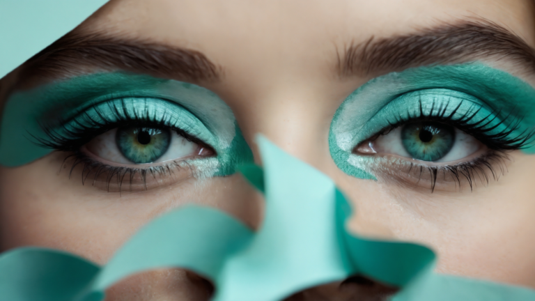 Close-up of turquoise eyeshadow with natural brows, teal paper cutouts framing face, luxury beauty makeup detail portrait.