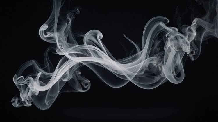 Delicate swirling white smoke wisps curling and twisting on a dark black background creating an abstract effect