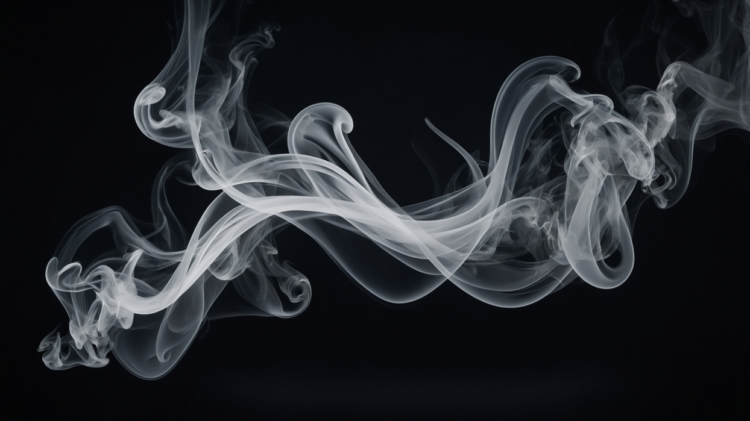 Delicate swirling white smoke wisps curling and twisting on a dark black background creating an abstract effect