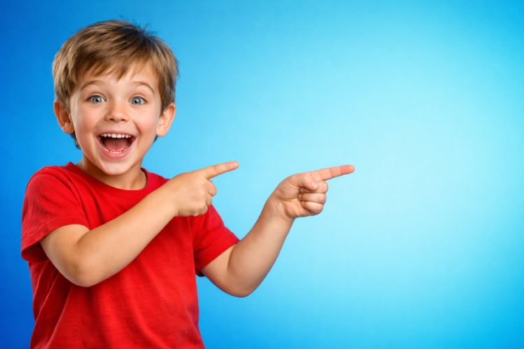 Happy young boy in red shirt enthusiastically pointing to the right on blue gradient background