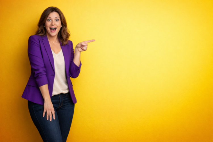 Happy woman in purple blazer excitedly pointing to the right side against a bright yellow background with empty space