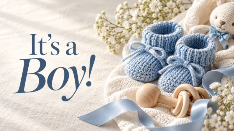 Knitted blue baby booties with wooden rattle and soft white flowers on beige fabric with baby announcement text